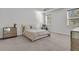 Bright main bedroom features neutral tones, carpeted floors, natural light, and mirrored nightstands at 1144 Wading Point Blvd, Huger, SC 29450