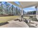 Spacious covered patio overlooking a large, fenced backyard at 1144 Wading Point Blvd, Huger, SC 29450
