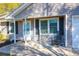 Close-up view of the inviting front porch with a 'Welcome' sign and a rocking chair at 115 Tennyson Way, Summerville, SC 29486