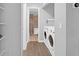 Hallway with laundry and bathroom featuring modern washer/dryer set and tiled shower at 115 Tennyson Way, Summerville, SC 29486