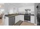Well-lit kitchen with stainless steel appliances, contrasting countertops, and ample cabinet space at 115 Tennyson Way, Summerville, SC 29486