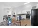 Open-concept kitchen with white cabinets, modern appliances, and seamless flow to living spaces at 115 Tennyson Way, Summerville, SC 29486