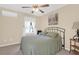 Cozy bedroom with a metal frame bed, soft green linens, and large window allowing natural light to fill the room at 1162 South Shadow Dr, Mount Pleasant, SC 29464