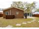 Exterior view of a brick home with a sunroom and backyard patio at 1162 South Shadow Dr, Mount Pleasant, SC 29464