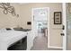 Laundry room with neutral walls, modern washer and dryer, and doorway leading to the kitchen and dining area at 1162 South Shadow Dr, Mount Pleasant, SC 29464
