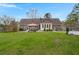 Expansive backyard with lush greenery, a pergola-covered patio, and a fenced pool area for outdoor enjoyment at 117 Hartin Blvd, Summerville, SC 29486