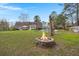 Expansive backyard with a stone fire pit, fenced pool, and covered patio for outdoor enjoyment at 117 Hartin Blvd, Summerville, SC 29486
