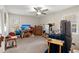 Spacious bedroom featuring a ceiling fan, mounted TV, and comfortable seating, creating a cozy retreat at 117 Hartin Blvd, Summerville, SC 29486