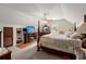 Charming bedroom boasts a four-poster bed, a TV over a fireplace, and built-in shelving for ample storage at 117 Hartin Blvd, Summerville, SC 29486