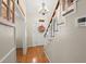 Welcoming entryway with hardwood floors, staircase, decorative wreath, and stylish light fixture at 117 Hartin Blvd, Summerville, SC 29486