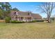 Traditional-style home with well-maintained lawn and shrubs, complemented by American flags at 117 Hartin Blvd, Summerville, SC 29486