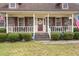 Inviting front porch with decorative elements, a 'Welcome' sign, and neatly trimmed bushes at 117 Hartin Blvd, Summerville, SC 29486
