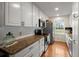Well-lit kitchen featuring granite countertops, stainless appliances and white cabinets at 117 Hartin Blvd, Summerville, SC 29486