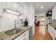 Modern kitchen showcasing granite countertops and white cabinets flowing into living area at 117 Hartin Blvd, Summerville, SC 29486