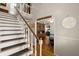 Elegant staircase with wood railing and partial carpet, adjacent to a dining room entrance at 117 Hartin Blvd, Summerville, SC 29486