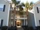 Exterior view of condo with palm trees and entry to units 1201 and 1205 at 1204 Grove Park Dr, Charleston, SC 29414
