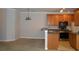 Open kitchen with wooden cabinets, stainless steel appliances, and breakfast bar at 1204 Grove Park Dr, Charleston, SC 29414