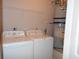 Laundry area featuring a washer, dryer, water heater, and storage shelves at 1204 Grove Park Dr, Charleston, SC 29414