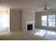 Bright living room with fireplace, ceiling fan, and natural light at 1204 Grove Park Dr, Charleston, SC 29414
