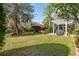 The backyard features a patio with a pergola, a healthy lawn, and several trees at 123 Thousand Oaks Ct, Summerville, SC 29485