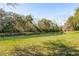 The backyard features a pond that is surrounded by grass and several trees at 123 Thousand Oaks Ct, Summerville, SC 29485