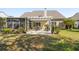This backyard has a patio with a pergola, lush landscaping, and healthy grass at 123 Thousand Oaks Ct, Summerville, SC 29485