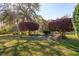 The backyard features two landscaped areas with purple trees, healthy grass, and landscaping at 123 Thousand Oaks Ct, Summerville, SC 29485