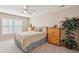 Bedroom with a bed with a light floral comforter, plantation shutters, and wooden dressers at 123 Thousand Oaks Ct, Summerville, SC 29485