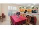 Dining area with a view into the kitchen, featuring light cabinets, black appliances, and modern lighting at 123 Thousand Oaks Ct, Summerville, SC 29485
