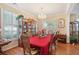 Bright dining room with a chandelier, wooden floors, and a built-in china cabinet at 123 Thousand Oaks Ct, Summerville, SC 29485