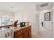 Hallway with chandelier and wood railing, leading to bedrooms and carpeted flooring at 123 Thousand Oaks Ct, Summerville, SC 29485