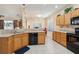 Kitchen featuring light-colored cabinets, black appliances, and views into the adjacent dining area at 123 Thousand Oaks Ct, Summerville, SC 29485