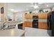 Spacious kitchen with light cabinets, a black appliance suite, and ample counter space at 123 Thousand Oaks Ct, Summerville, SC 29485