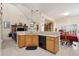 Open kitchen with adjacent living and dining areas, bright cabinets, and black appliances at 123 Thousand Oaks Ct, Summerville, SC 29485