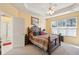Main bedroom with tray ceilings, a ceiling fan, and windows for natural light at 123 Thousand Oaks Ct, Summerville, SC 29485