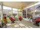 Bright sunroom with wicker furniture, a ceiling fan, and large windows with garden views at 123 Thousand Oaks Ct, Summerville, SC 29485