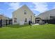 Spacious backyard featuring a lush green lawn, fencing, and an outdoor dining area with grill at 1249 Shadow Mist Ln, Charleston, SC 29492
