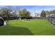 Large, grassy backyard with a fire pit surrounded by chairs, perfect for outdoor entertaining at 1249 Shadow Mist Ln, Charleston, SC 29492