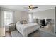 Cozy bedroom features neutral colors, hardwood floors, a ceiling fan, and natural light from large windows at 1249 Shadow Mist Ln, Charleston, SC 29492