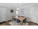 Dining room with a light wood table, six gray chairs, and modern light fixture at 1249 Shadow Mist Ln, Charleston, SC 29492