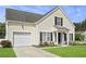 Two-story home featuring a garage, manicured lawn, and a welcoming front entrance at 1249 Shadow Mist Ln, Charleston, SC 29492