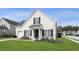Charming, light yellow, two-story home with black shutters and a well-manicured lawn at 1249 Shadow Mist Ln, Charleston, SC 29492