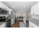 Bright eat-in kitchen features stainless steel appliances, granite counters, white cabinets, and tile backsplash at 1249 Shadow Mist Ln, Charleston, SC 29492