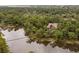Aerial view of wooded property with water access and dock at 127 Blue Heron Pond Rd # A, Kiawah Island, SC 29455