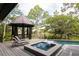 Lounge in the beautiful backyard with gazebo, hot tub, and pool at 127 Blue Heron Pond Rd # A, Kiawah Island, SC 29455