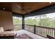 Outdoor balcony with ceiling fan, wood railings, and beautiful views of surrounding trees at 127 Blue Heron Pond Rd # A, Kiawah Island, SC 29455