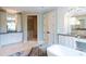 Bright bathroom with a vanity, tiled shower, and a freestanding tub at 127 Blue Heron Pond Rd # A, Kiawah Island, SC 29455