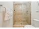 Neutral toned bathroom featuring a glass enclosed tiled shower and toilet at 127 Blue Heron Pond Rd # A, Kiawah Island, SC 29455