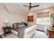 Comfortable bedroom featuring a ceiling fan, area rug, and stylish decor at 127 Blue Heron Pond Rd # A, Kiawah Island, SC 29455