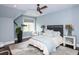 Cozy bedroom with a ceiling fan, large window, and neutral-colored decor at 127 Blue Heron Pond Rd # A, Kiawah Island, SC 29455